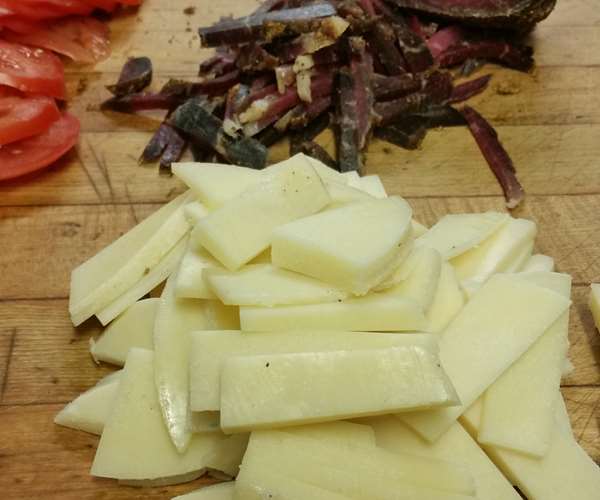 The makings of pita kaisarias (tomatoes, kasseri cheese and pastourma) 